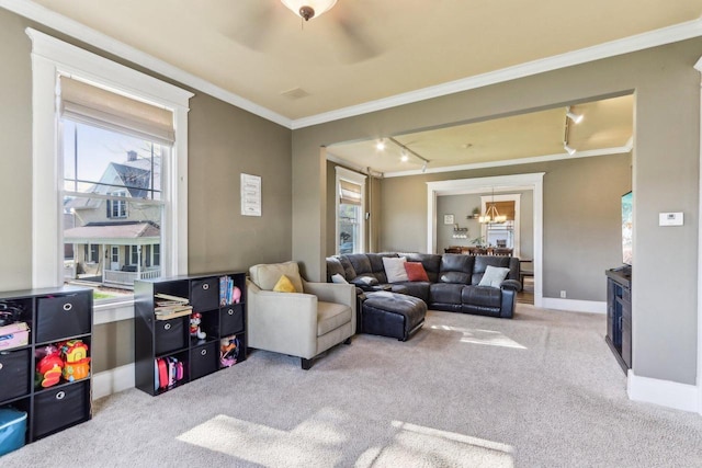 114 E Washington St, West Bend, WI 53095 - carpeted living room featuring crown molding, healthy amount of natural light, track lighting, baseboards, and a chandelier