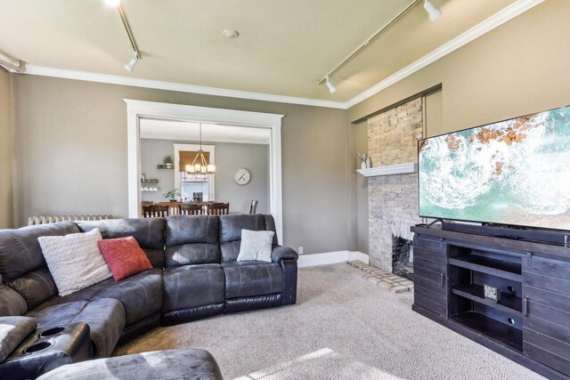 114 E Washington St, West Bend, WI 53095 - living area featuring track lighting, carpet, ornamental molding, a chandelier, and a fireplace