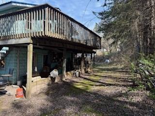 view of side of property featuring a wooden deck