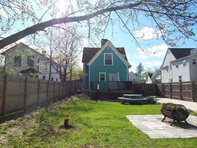929 Park Ave, Beloit, WI 53511 - view of yard with a wooden deck, a fire pit, and a patio