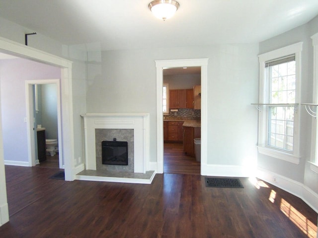 929 Park Ave, Beloit, WI 53511 - unfurnished living room with dark wood-type flooring, a premium fireplace, and baseboards