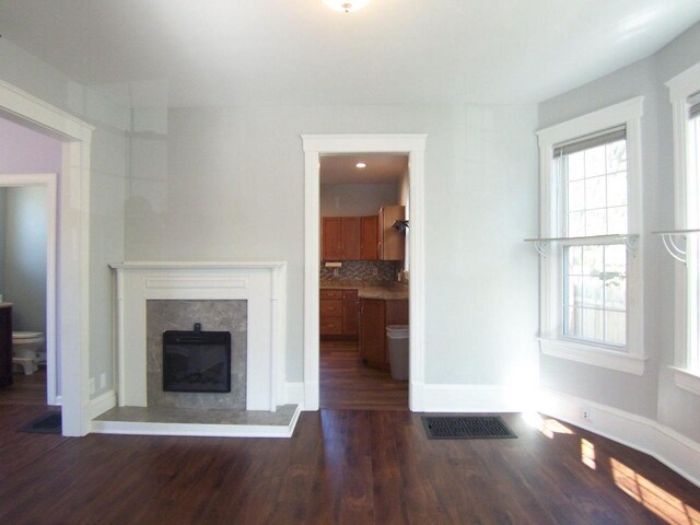 929 Park Ave, Beloit, WI 53511 - unfurnished living room with wood finished floors, a high end fireplace, and baseboards