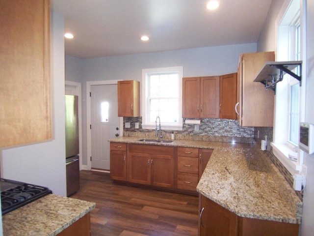 929 Park Ave, Beloit, WI 53511 - kitchen with a sink, brown cabinets, decorative backsplash, freestanding refrigerator, and recessed lighting