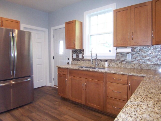 929 Park Ave, Beloit, WI 53511 - kitchen featuring freestanding refrigerator, a sink, brown cabinets, backsplash, and dark wood-style flooring