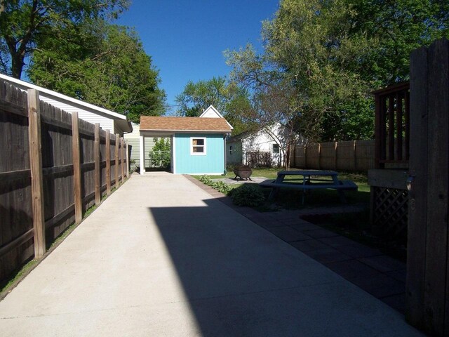 929 Park Ave, Beloit, WI 53511 - view of patio with an outbuilding, a fenced backyard, and a storage unit