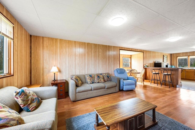 2965 S Stevenson Pier Rd, Sturgeon Bay, WI 54204 - living room with light wood-type flooring, wooden walls, and a drop ceiling