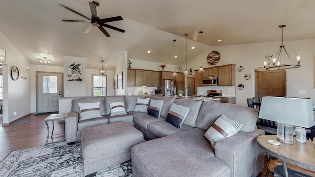 2239 E Honeygold Ct, Appleton, WI 54913 - living area featuring a chandelier, dark wood-type flooring, a ceiling fan, and high vaulted ceiling