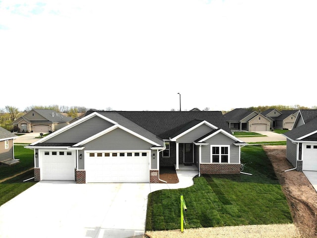 2239 E Honeygold Ct, Appleton, WI 54913 - view of front facade featuring brick siding, a residential view, driveway, and a front yard