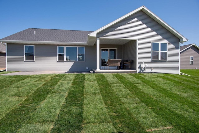 2239 E Honeygold Ct, Appleton, WI 54913 - back of property with a patio area, a yard, and a shingled roof