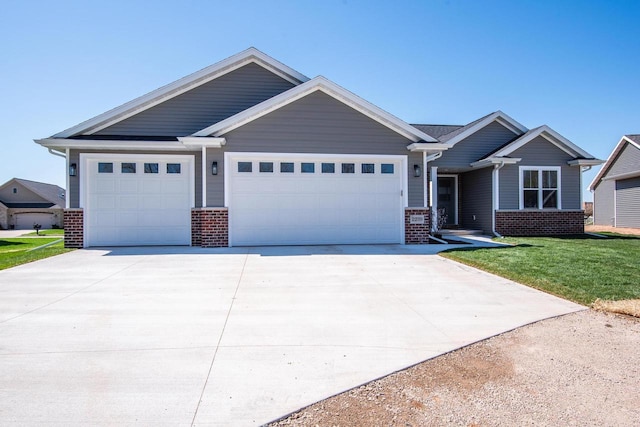 2239 E Honeygold Ct, Appleton, WI 54913 - craftsman house with brick siding, a garage, driveway, and a front yard