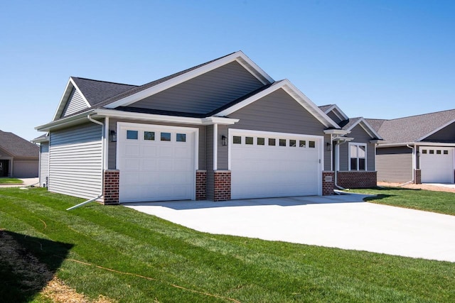2239 E Honeygold Ct, Appleton, WI 54913 - view of front of property with brick siding, a garage, concrete driveway, and a front lawn