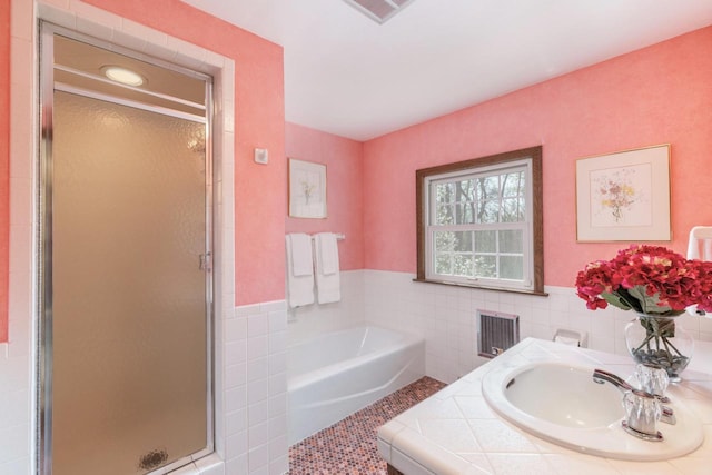2305 W County Line Rd, River Hills, WI 53217 - full bath with tile walls, a sink, a stall shower, a bath, and a wainscoted wall