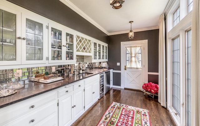 2305 W County Line Rd, River Hills, WI 53217 - kitchen featuring white cabinetry, glass insert cabinets, dark wood finished floors, backsplash, and a sink