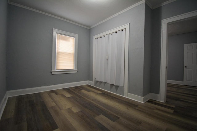 2625 N 50th St, Milwaukee, WI 53210 - unfurnished bedroom featuring dark wood-type flooring, crown molding, baseboards, and a closet