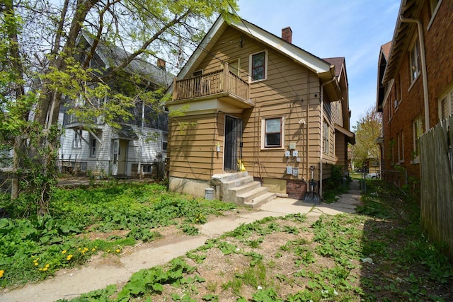 2625 N 50th St, Milwaukee, WI 53210 - view of front of house with a balcony, fence, and a chimney