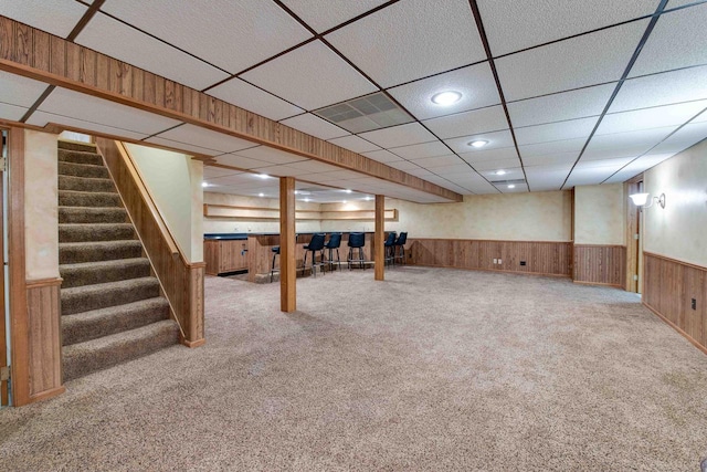 8200 43rd Ave, Kenosha, WI 53142 - finished below grade area with a wainscoted wall, stairs, carpet, a paneled ceiling, and wooden walls