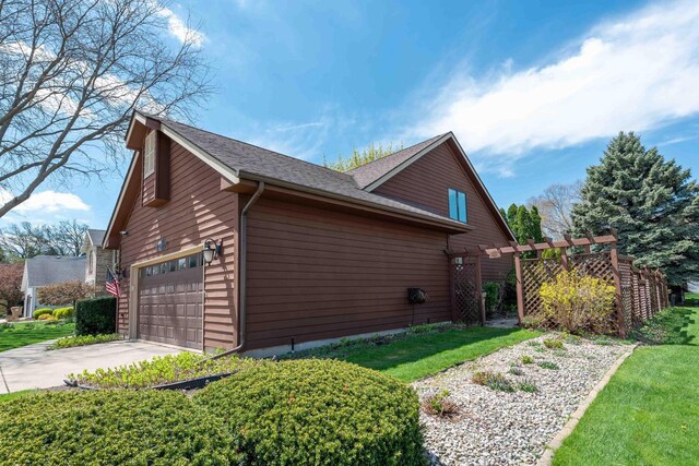 8200 43rd Ave, Kenosha, WI 53142 - view of home's exterior with a garage, driveway, a lawn, and a shingled roof
