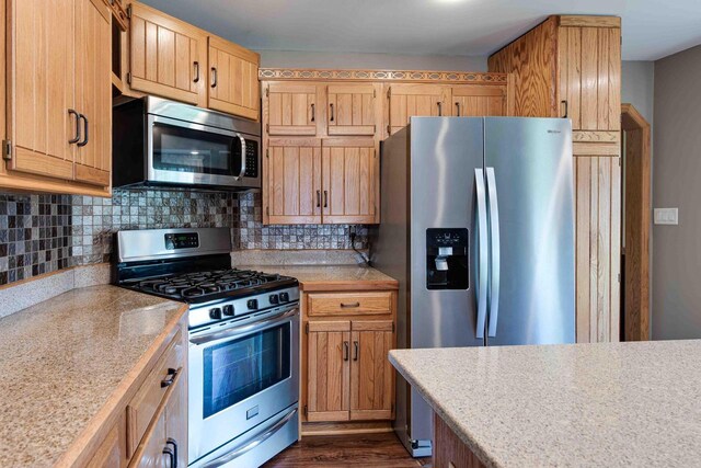 8200 43rd Ave, Kenosha, WI 53142 - kitchen featuring appliances with stainless steel finishes, light countertops, decorative backsplash, and dark wood-style floors
