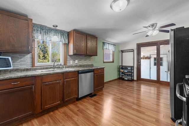 3500 W Justin St, Appleton, WI 54914 - kitchen featuring stainless steel dishwasher, a sink, range with electric stovetop, backsplash, and light wood finished floors
