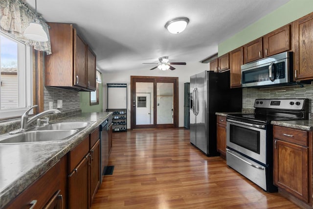 3500 W Justin St, Appleton, WI 54914 - kitchen with stainless steel appliances, a sink, a ceiling fan, and backsplash