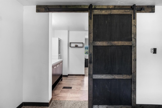 3500 W Justin St, Appleton, WI 54914 - kitchen with a barn door and baseboards