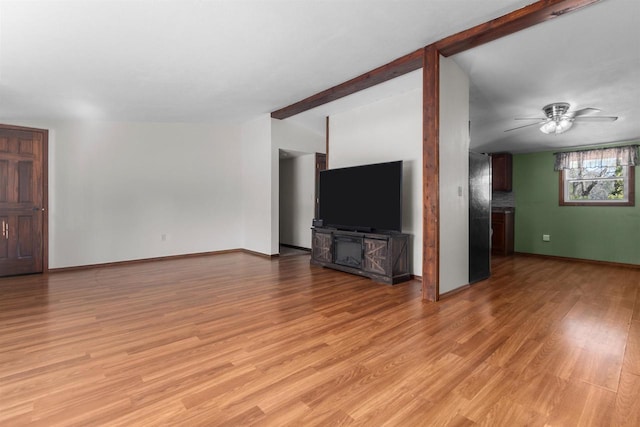 3500 W Justin St, Appleton, WI 54914 - unfurnished living room with a ceiling fan, light wood-type flooring, beamed ceiling, and baseboards
