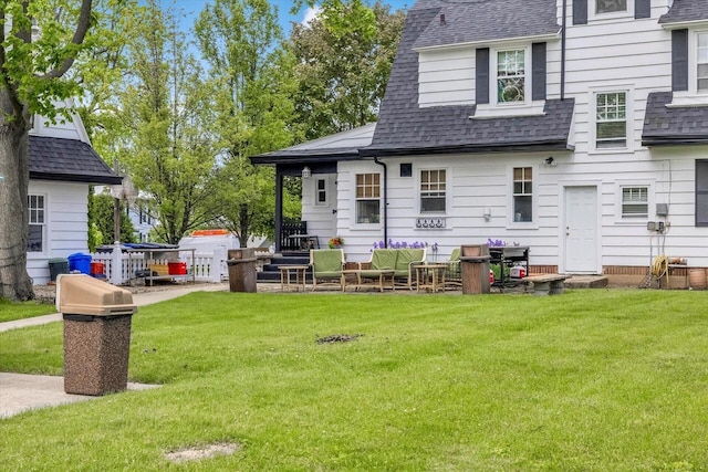 215 W Walworth St, Elkhorn, WI 53121 - back of house with roof with shingles and a yard