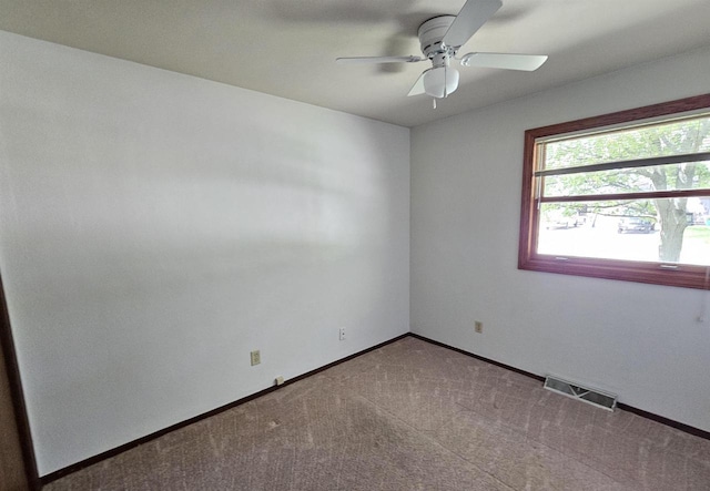 1247 Goss Ave, Menasha, WI 54952 - spare room featuring a ceiling fan, carpet floors, and baseboards