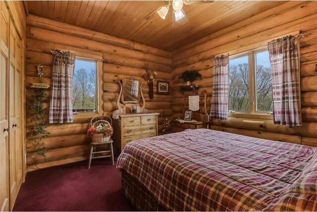 N5502 90th St, Elmwood, WI 54740 - bedroom featuring log walls, multiple windows, wood ceiling, and carpet flooring
