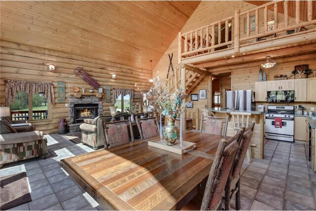 N5502 90th St, Elmwood, WI 54740 - dining area with high vaulted ceiling, wooden ceiling, a fireplace, log walls, and stairs