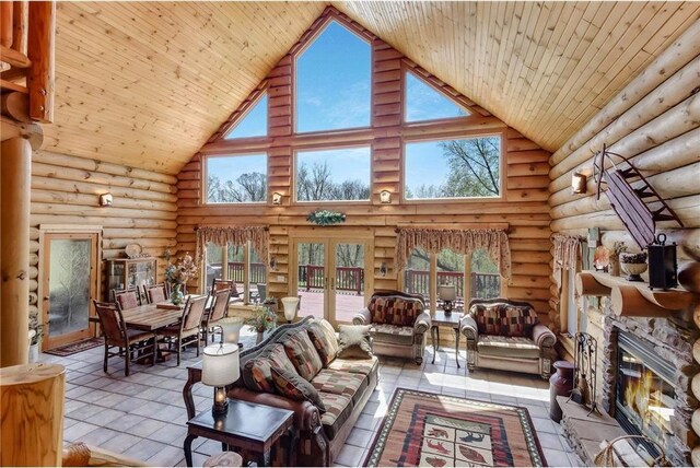 N5502 90th St, Elmwood, WI 54740 - living room with high vaulted ceiling, a fireplace, log walls, wooden ceiling, and tile patterned floors