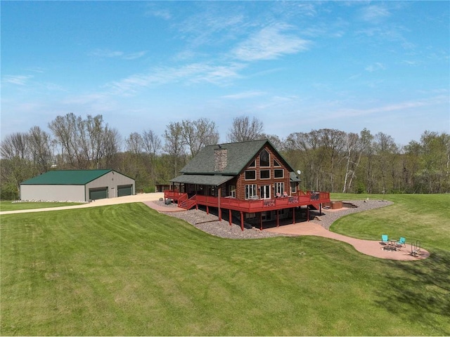 N5502 90th St, Elmwood, WI 54740 - back of house with a wooden deck, a detached garage, a lawn, an outdoor structure, and roof with shingles