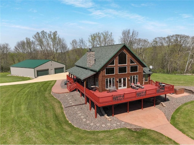 N5502 90th St, Elmwood, WI 54740 - rear view of house featuring log siding, a wooden deck, a detached garage, a yard, and a chimney