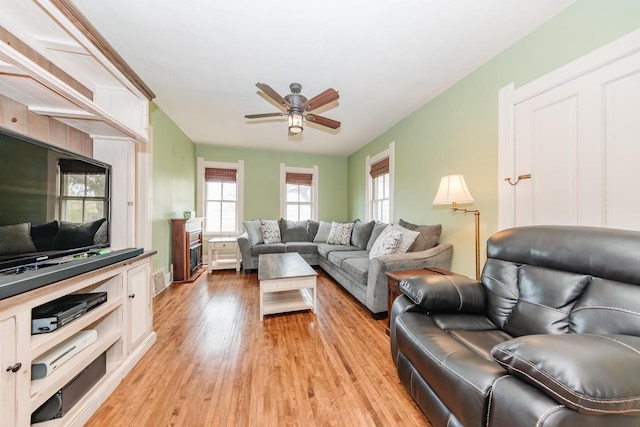 12220 W Highland Rd, Mequon, WI 53097 - living area with a ceiling fan and light wood-style floors
