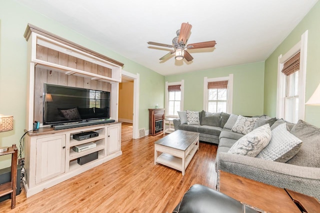 12220 W Highland Rd, Mequon, WI 53097 - living area featuring light wood-style flooring, ceiling fan, and baseboards