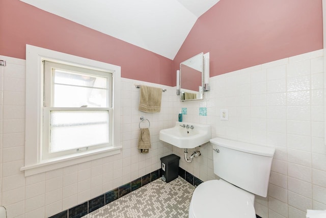 12220 W Highland Rd, Mequon, WI 53097 - half bath featuring toilet, vaulted ceiling, a sink, and tile walls