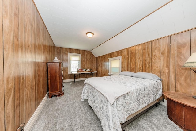 12220 W Highland Rd, Mequon, WI 53097 - carpeted bedroom featuring wood walls, vaulted ceiling, and baseboards