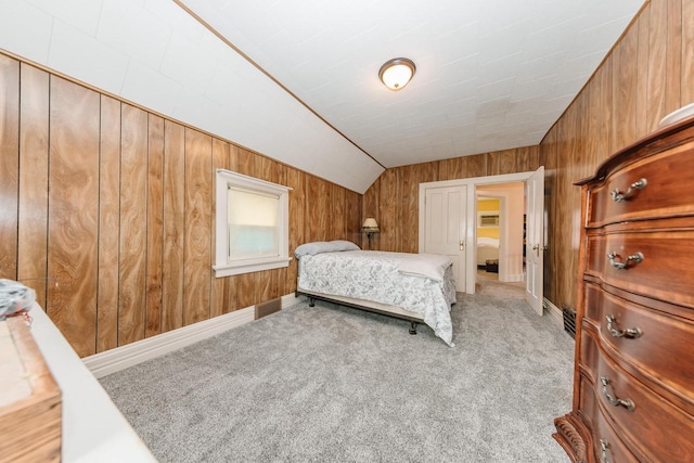 12220 W Highland Rd, Mequon, WI 53097 - carpeted bedroom with wooden walls, lofted ceiling, and baseboards
