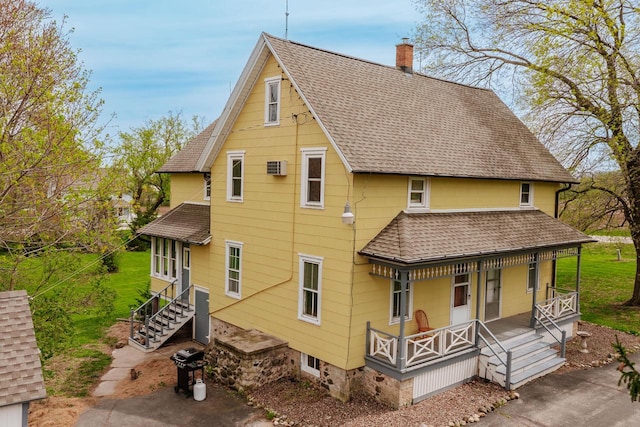 12220 W Highland Rd, Mequon, WI 53097 - back of house featuring a porch, a shingled roof, a chimney, and stairs