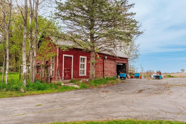 12220 W Highland Rd, Mequon, WI 53097 - view of outbuilding with asphalt driveway and a garage