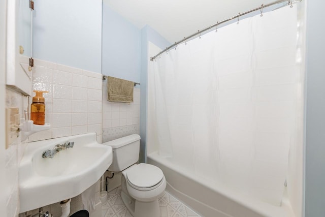 12220 W Highland Rd, Mequon, WI 53097 - bathroom featuring tile walls, toilet, a sink, and shower / tub combo