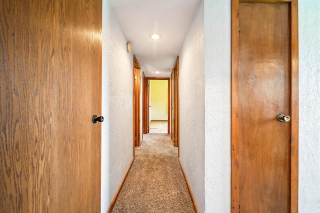 N8584 Snake Rd, Elkhart Lake, WI 53020 - corridor featuring a textured wall, carpet flooring, baseboards, and recessed lighting