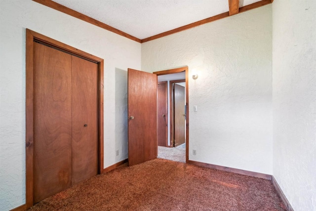 N8584 Snake Rd, Elkhart Lake, WI 53020 - unfurnished bedroom with a textured wall, carpet, a closet, and ornamental molding