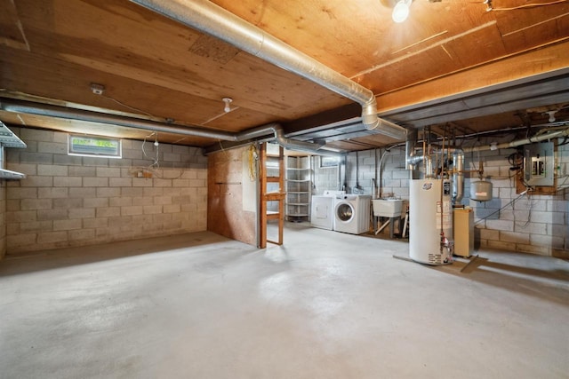 N8584 Snake Rd, Elkhart Lake, WI 53020 - below grade area featuring washing machine and clothes dryer, gas water heater, electric panel, and a sink