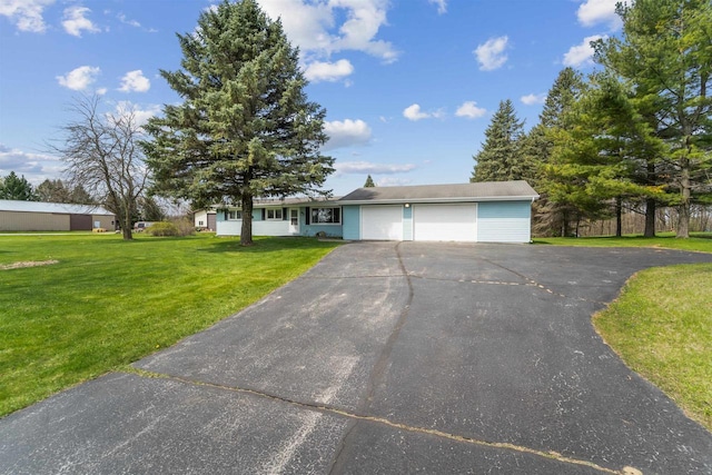 N8584 Snake Rd, Elkhart Lake, WI 53020 - single story home featuring asphalt driveway, an attached garage, and a front lawn