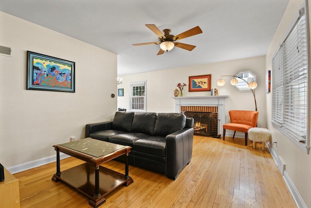 4105 Meyer Ave, Madison, WI 53711 - living room with a brick fireplace, light wood-type flooring, ceiling fan, and baseboards