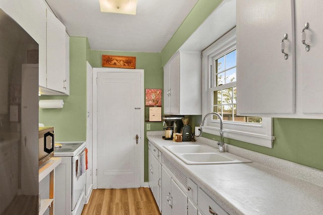 4105 Meyer Ave, Madison, WI 53711 - kitchen featuring white electric range oven, a sink, light countertops, and white cabinetry