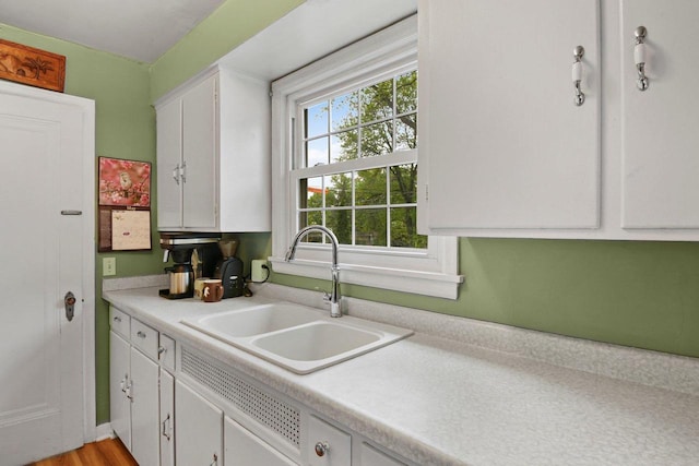4105 Meyer Ave, Madison, WI 53711 - kitchen featuring a sink, white cabinetry, and light countertops