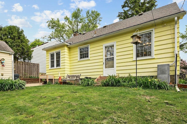 4105 Meyer Ave, Madison, WI 53711 - rear view of house with entry steps, a shingled roof, and a chimney