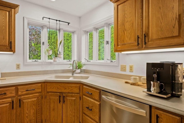 956 Kingston Cir, Sun Prairie, WI 53590 - kitchen with stainless steel dishwasher, plenty of natural light, a sink, and light countertops